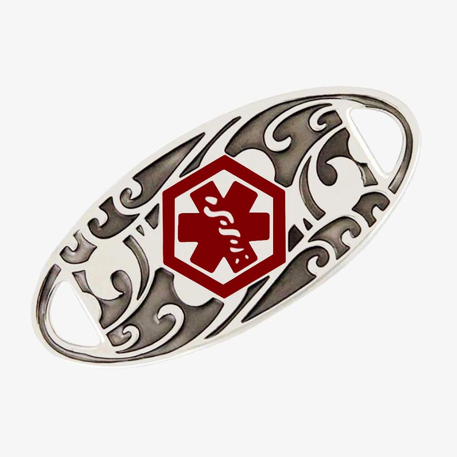 Stainless steel medical ID tag with a dark floral pattern and red medical symbol.