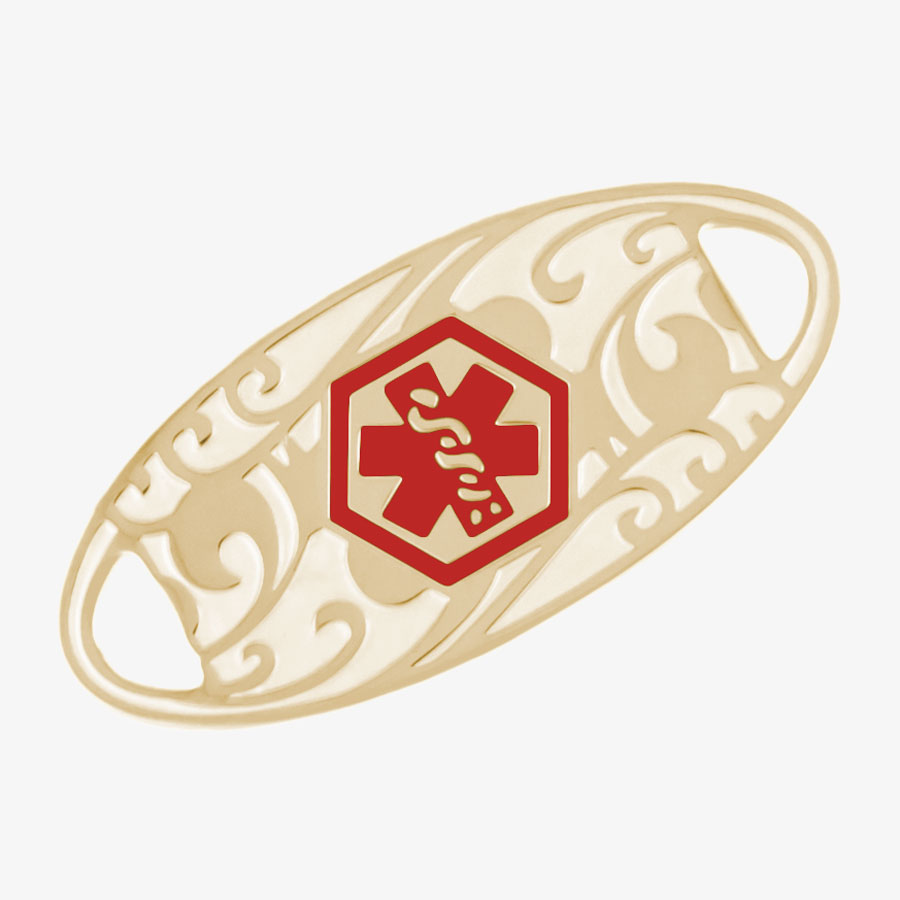 Oval-shaped gold-tone stainless steel medical alert tag with red medical symbol and scrolling filigree pattern