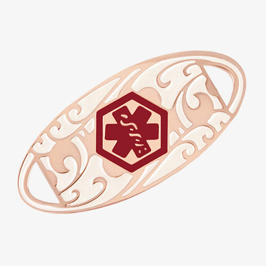 Rose gold tone oval medical alert tag with scrolling filigree pattern and red medical caduceus symbol