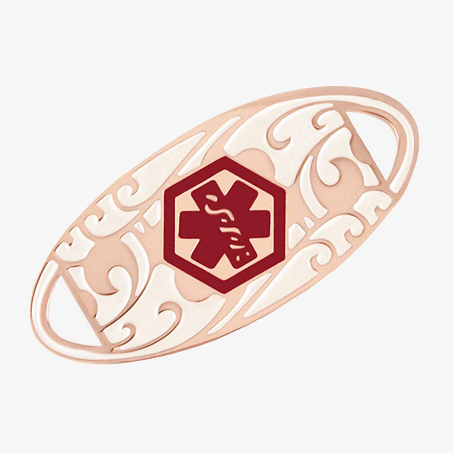 Rose gold tone oval medical alert tag with scrolling filigree pattern and red medical caduceus symbol