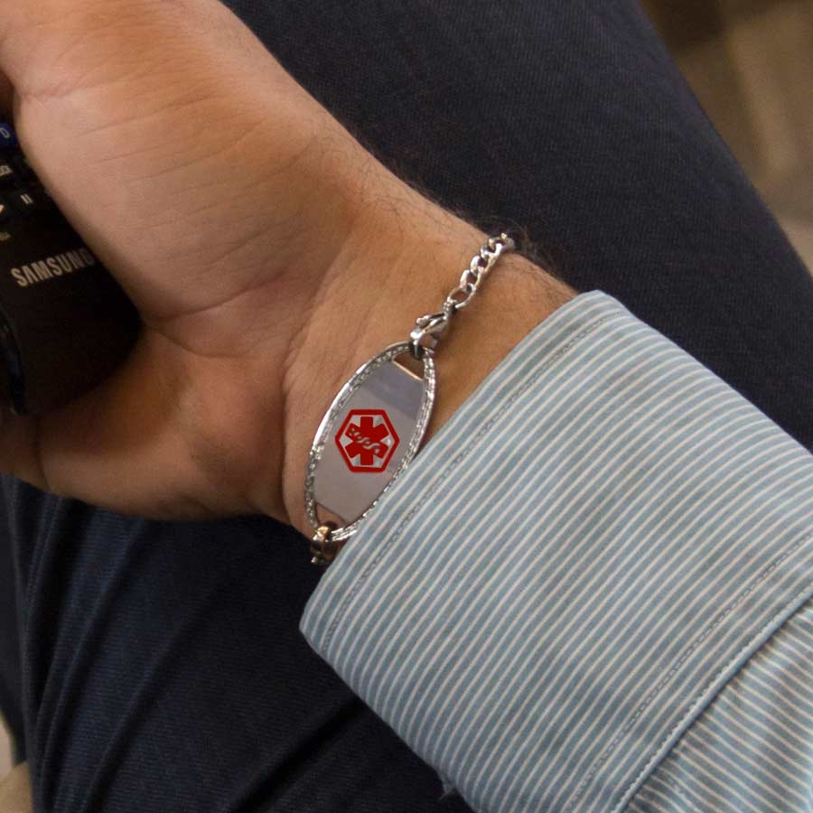 Man showing silver tone stainless steel medical alert tag with delicate stainless steel chain