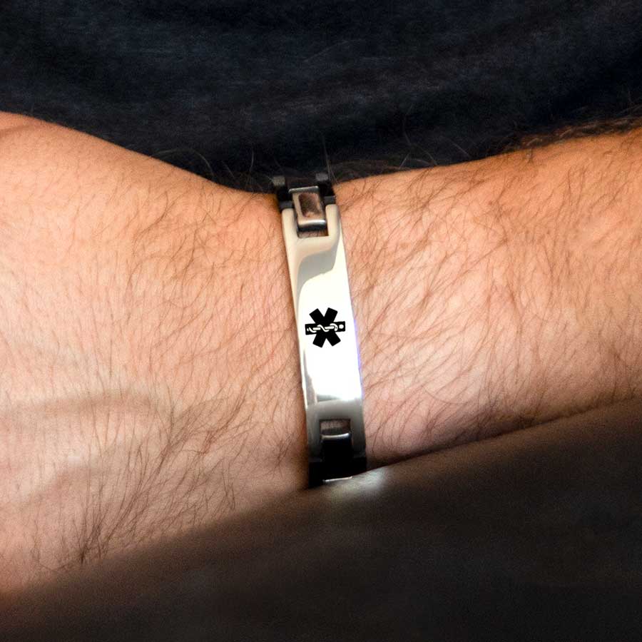 Man wearing the Ryder Medical ID Bracelet, a blend of stainless black and steel finished links, affixed tag, black caduceus