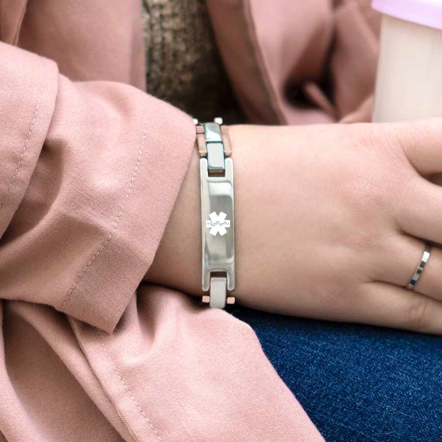 Woman wearing rose gold and silver two-tone linked medical ID bracelet