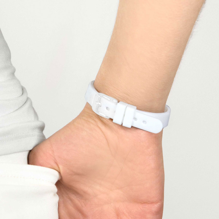 Woman wearing white silicone medical ID bracelet with watch style clasp