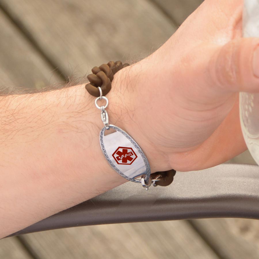 Man wearing brown silicone medical ID bracelet with silver lobster clasps