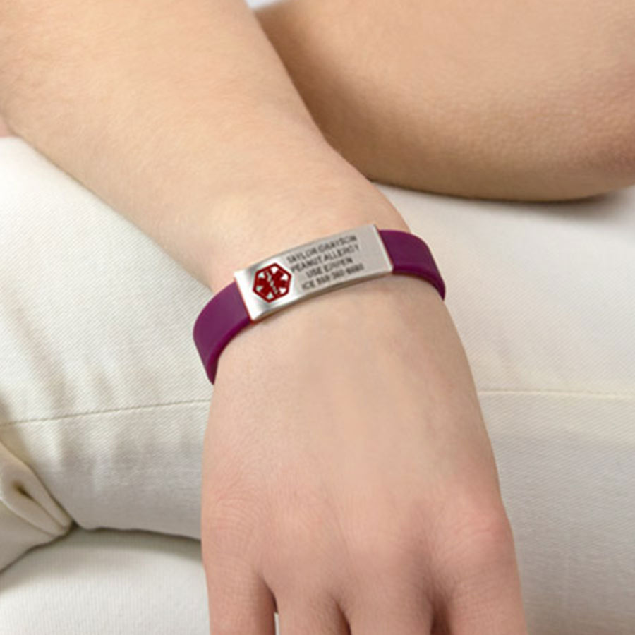 Woman wearing purple colored silicone medical alert activewear slim band