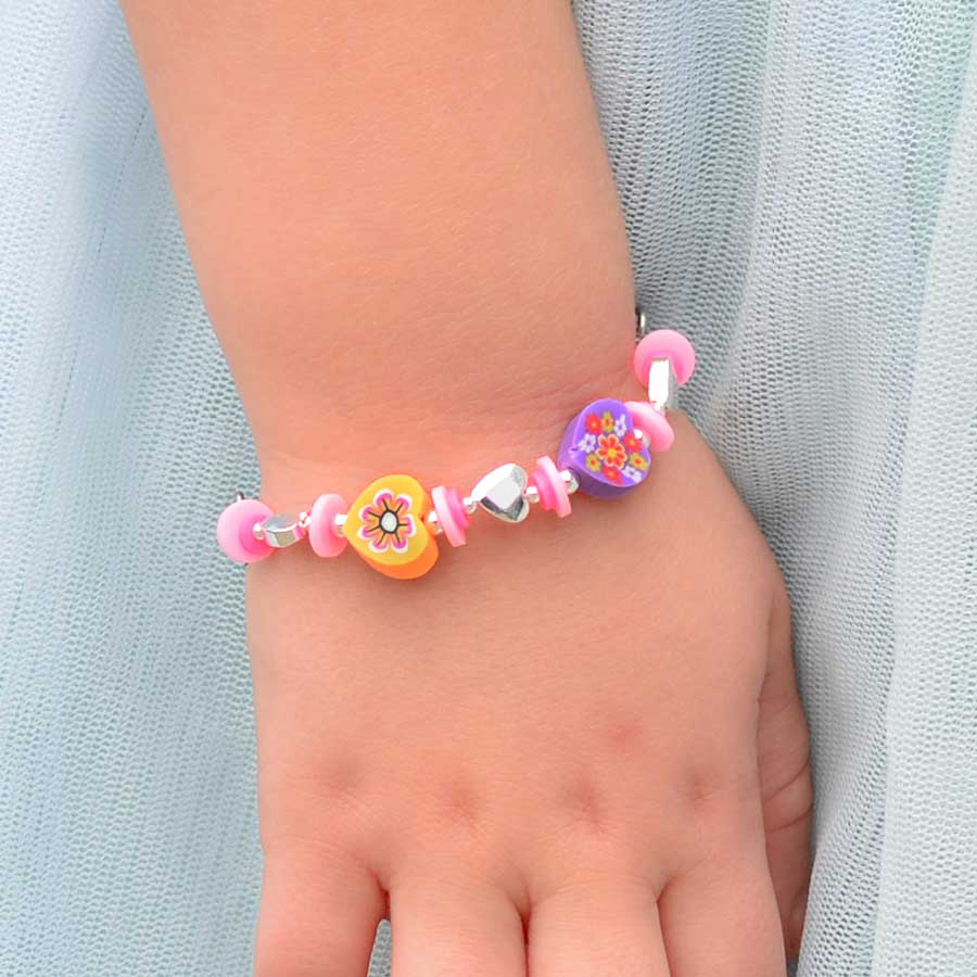 Little girl wearing Lanni Rainbow Heart Stretch Bracelet