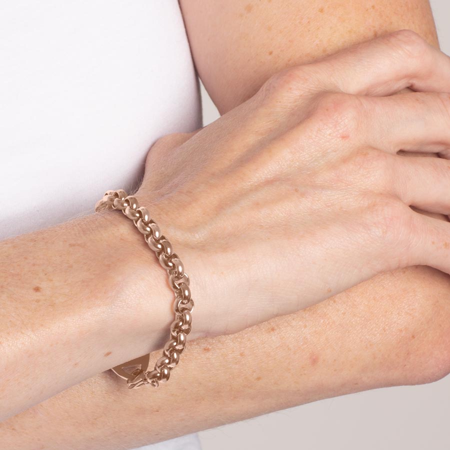 Woman wearing rose gold tone stainless steel rolo chain medical alert bracelet. 