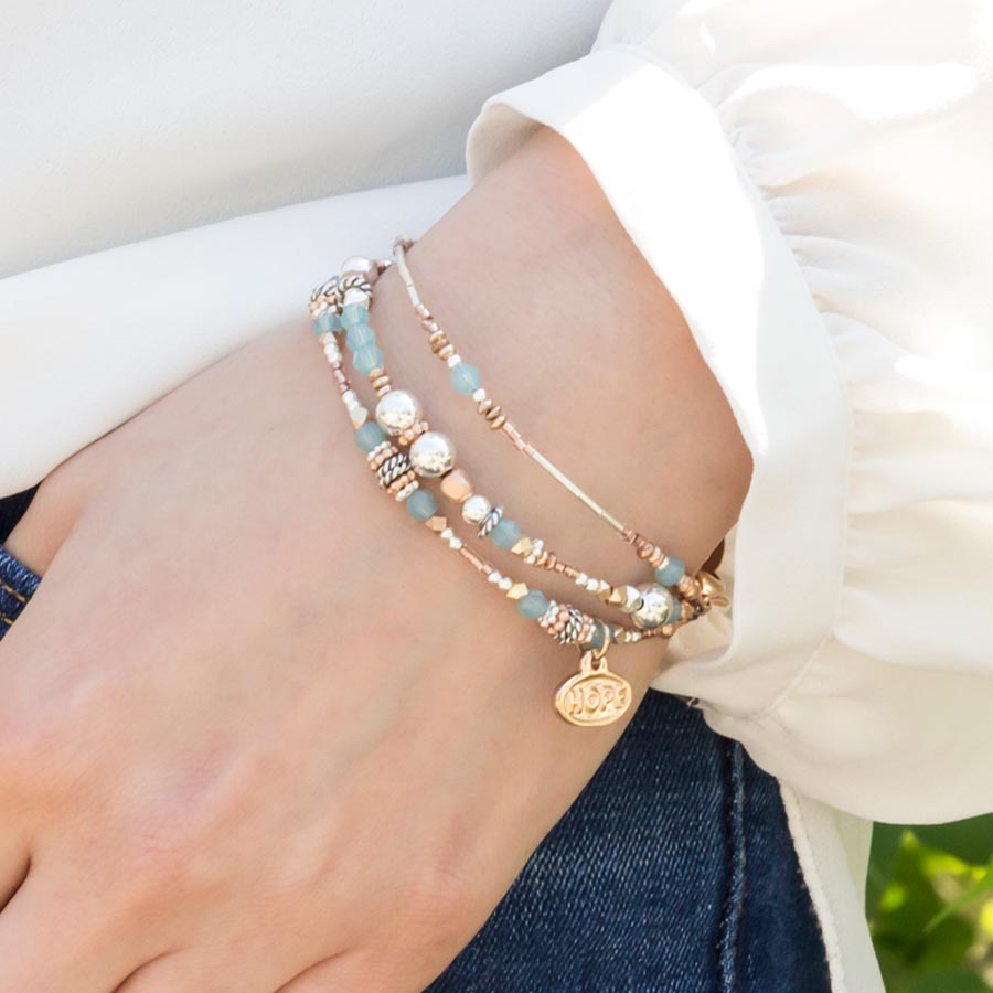 Interchangeable multi strand bracelet: Sterling silver, crystal, and rose gold tone beads shown on wrist