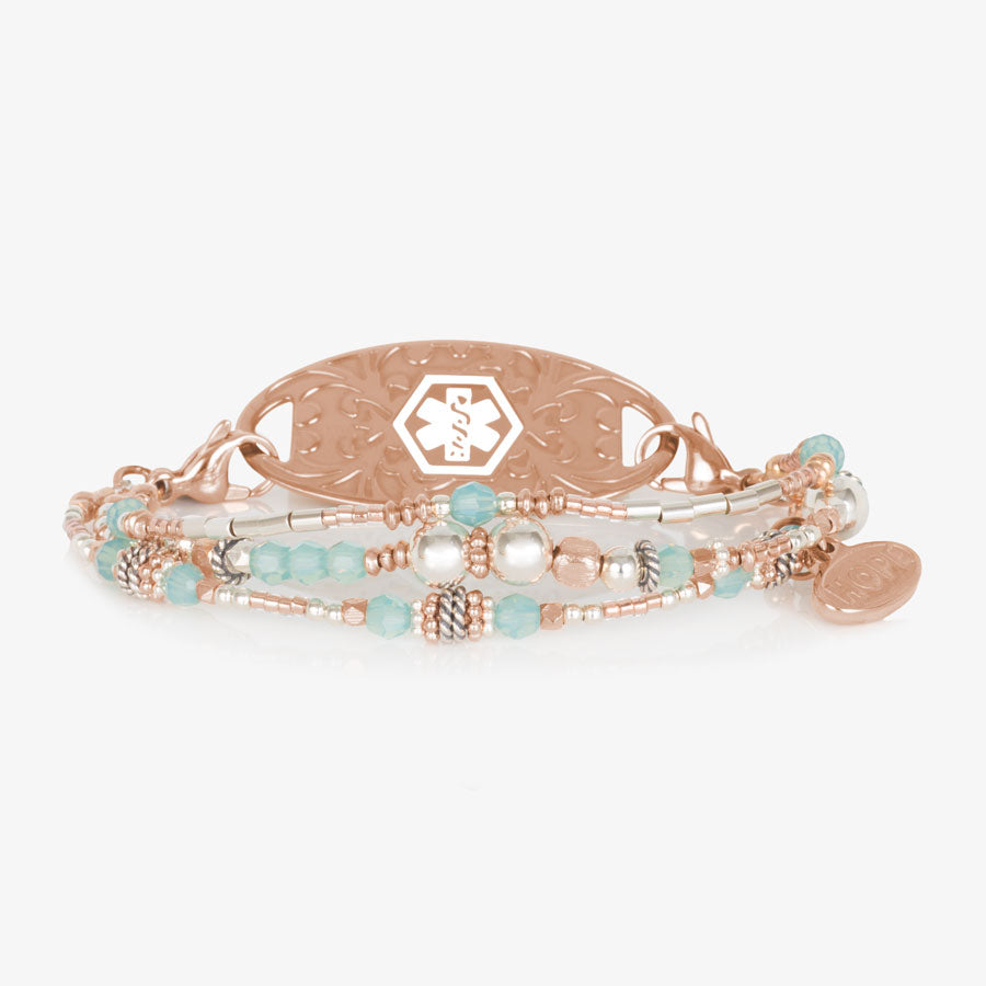 Mix and match bracelet with 3 strands of light blue and rose tone beads. Shown with a coordinating ID tag.