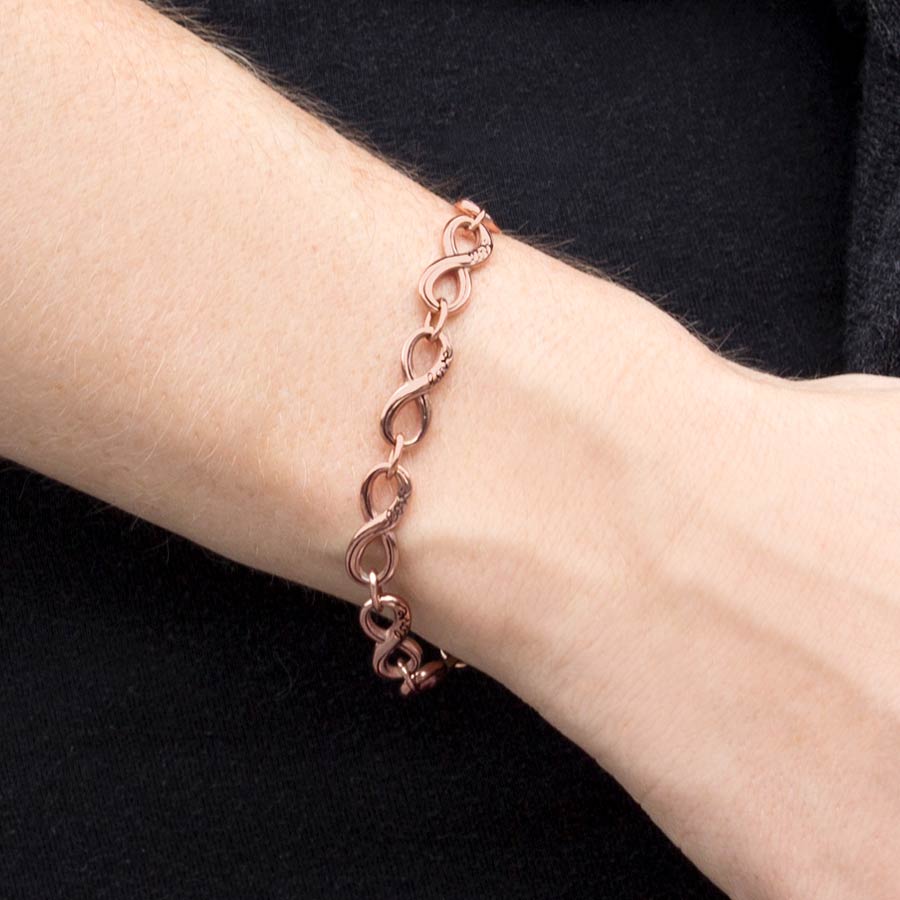 Woman wearing the Rose Gold Tone Forever and Always Medical ID, stainless infinity-symbol-shaped links, word “Love” each link