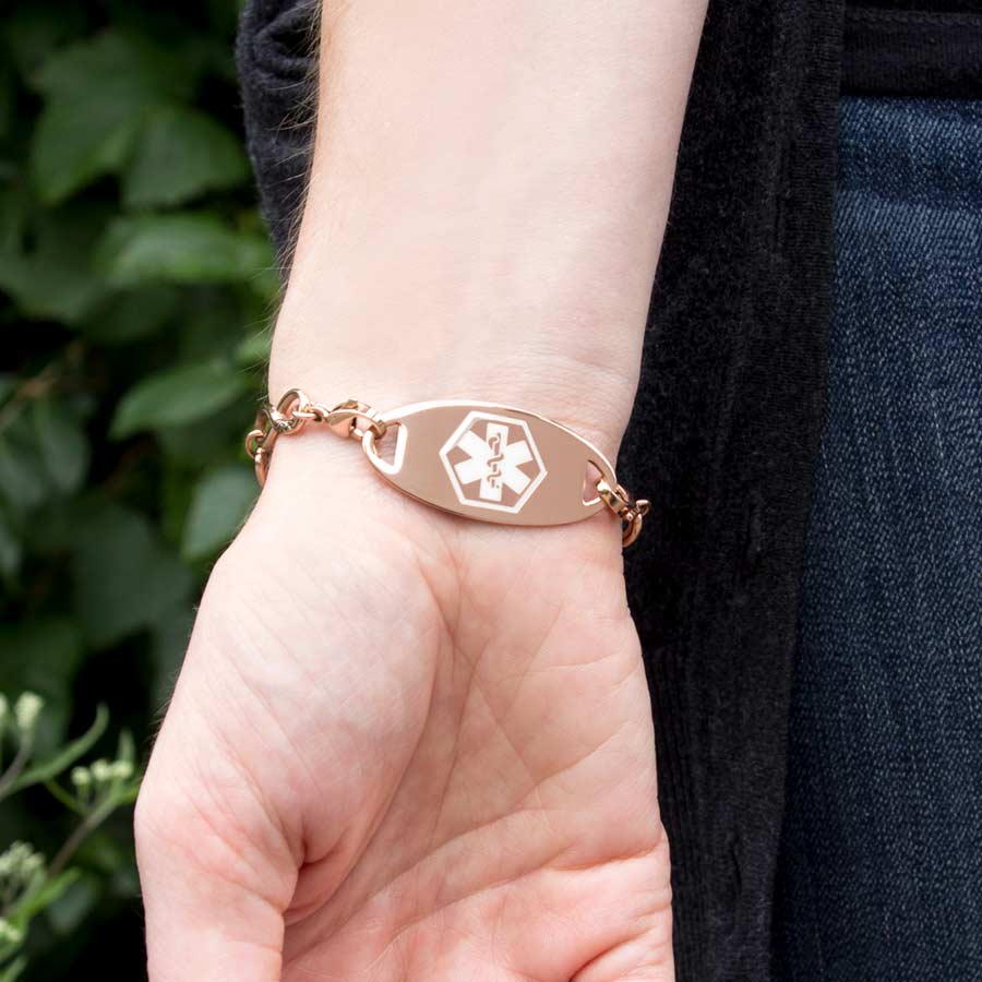 Woman wearing a Rose Gold Tone Oval Med ID Tag on a Forever and Always Medical ID with stainless infinity-symbol-shaped links