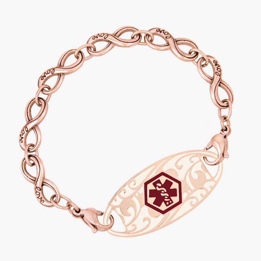 Rose gold tone infinity chain bracelet with "love" inscription on each link paired with decorative med ID tag with red symbol.