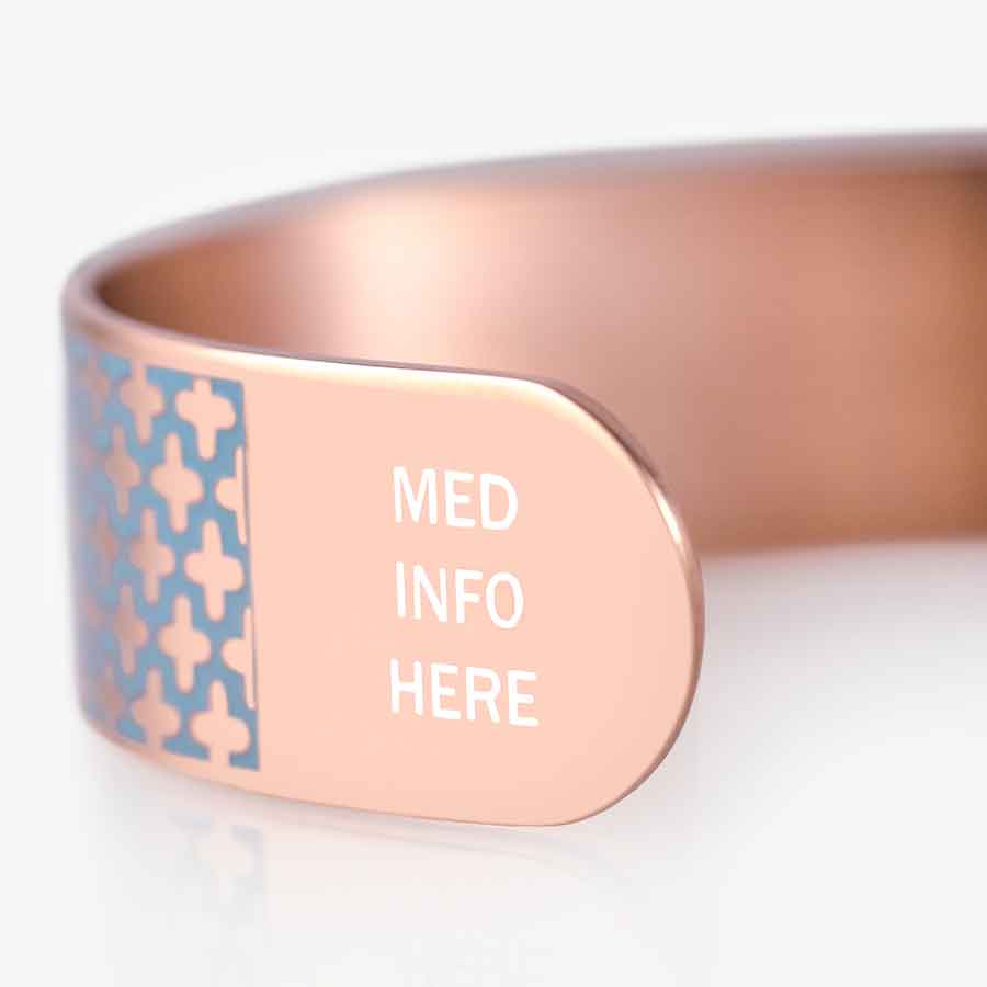 Side of rose gold medical ID cuff with MED INFO HERE embossed in white pain