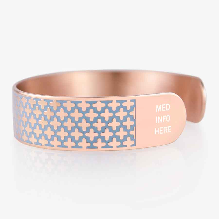 Side view of rose gold and blue medical ID cuff bracelet with decorative cross pattern in blue paint enamel