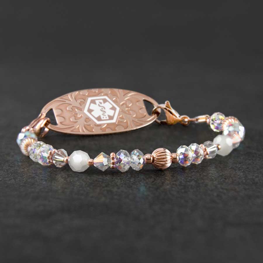 Krista Stretch Bracelet with rose gold beads and crystals and a rose gold tag with white medical ID symbol on slate