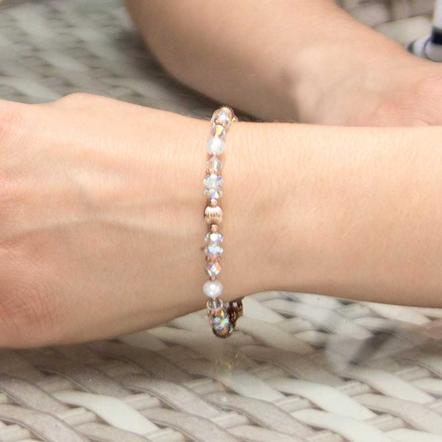 Woman wearing Krista Stretch Bracelet with rose gold beads and crystals