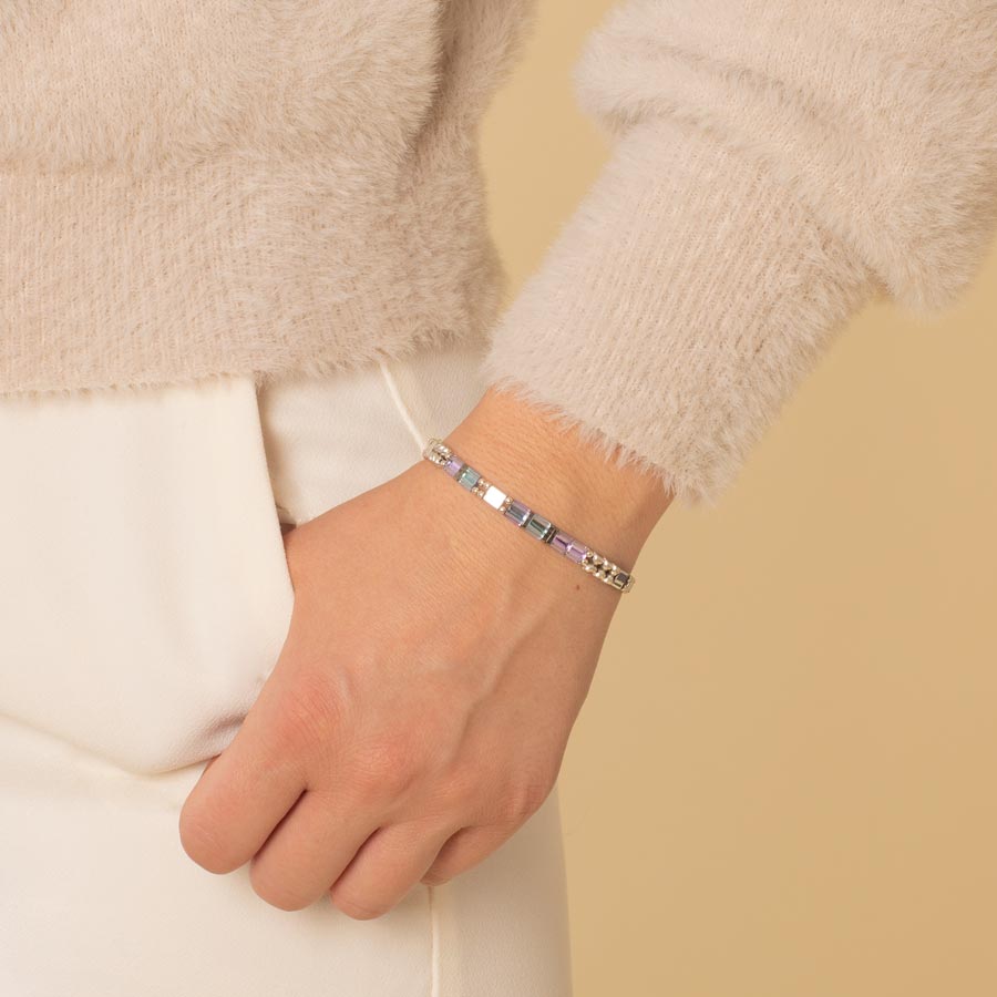 Woman wearing medical alert bracelet with flat pastel beads