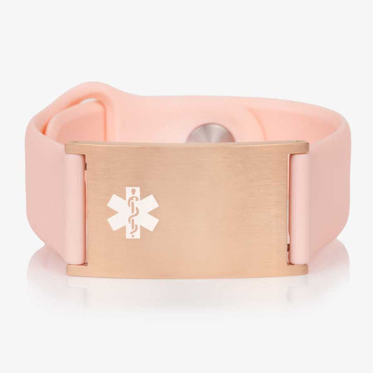 Low front angle of pink silicone band with adjustable strap and a rose gold tag and white caduceus symbol.