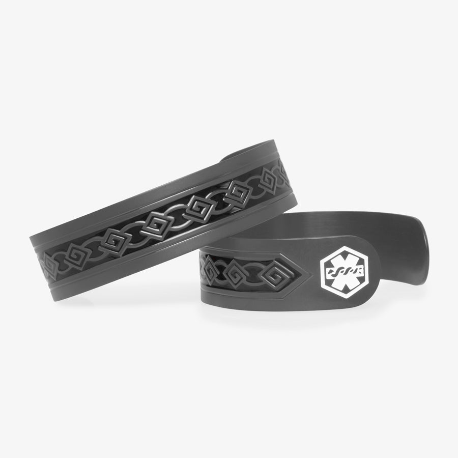 Sandblasted black stainless steel med ID cuff with tribal pattern and black patina inlay. White medical symbol at the end of the cuff.