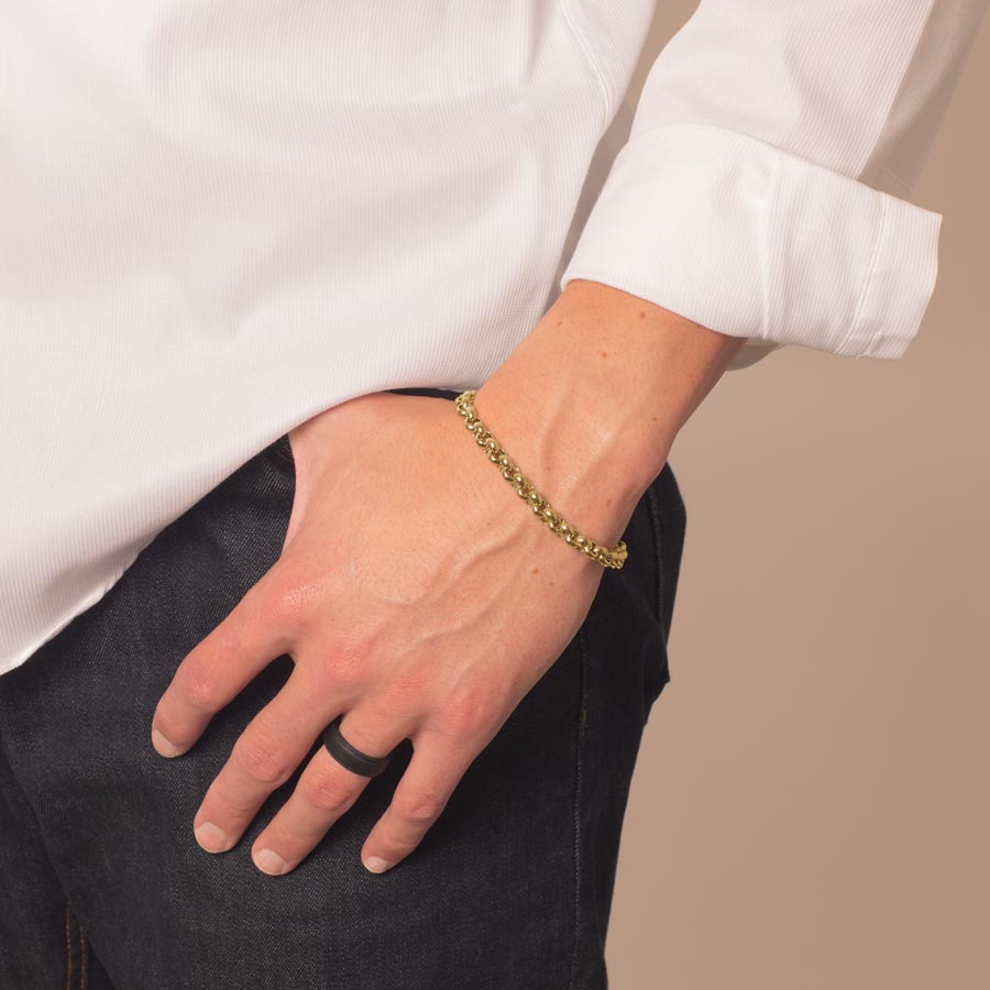 Man wearing gold tone stainless steel rolo chain medical ID bracelet.