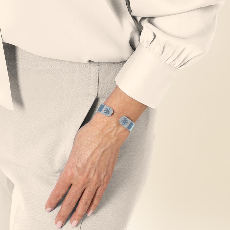 Woman wearing medical alert cuff with varying shares of blue color