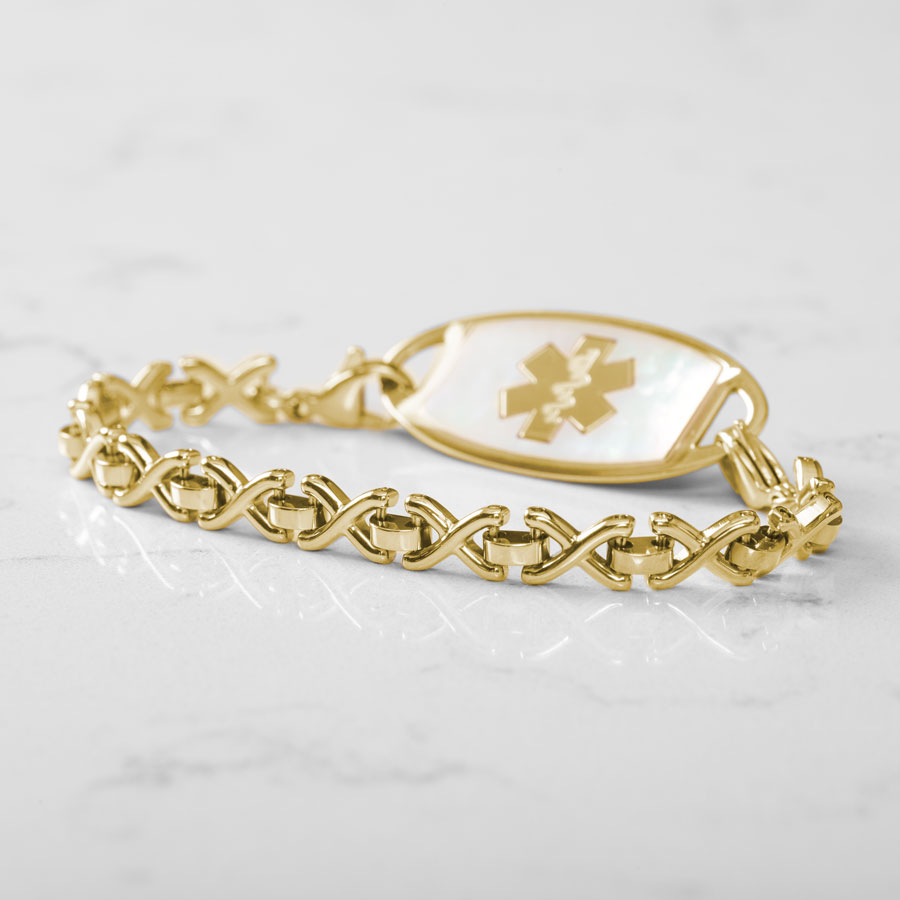 Lenox Medical ID Bracelet featuring X-shaped links in gold tone stainless steel, attached to gold medical ID tag with inlaid Mother of Pearl