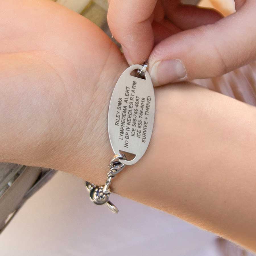 Sample engraved text on back of medical ID tag shown on wrist