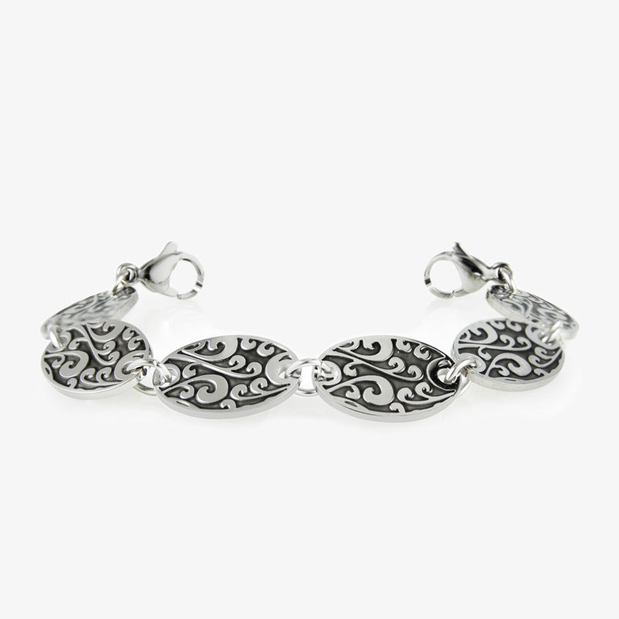 Med ID bracelet with six 3/4" by 1/2" links with detailed, black-filled scroll work pattern. Silver tone stainless med ID tag