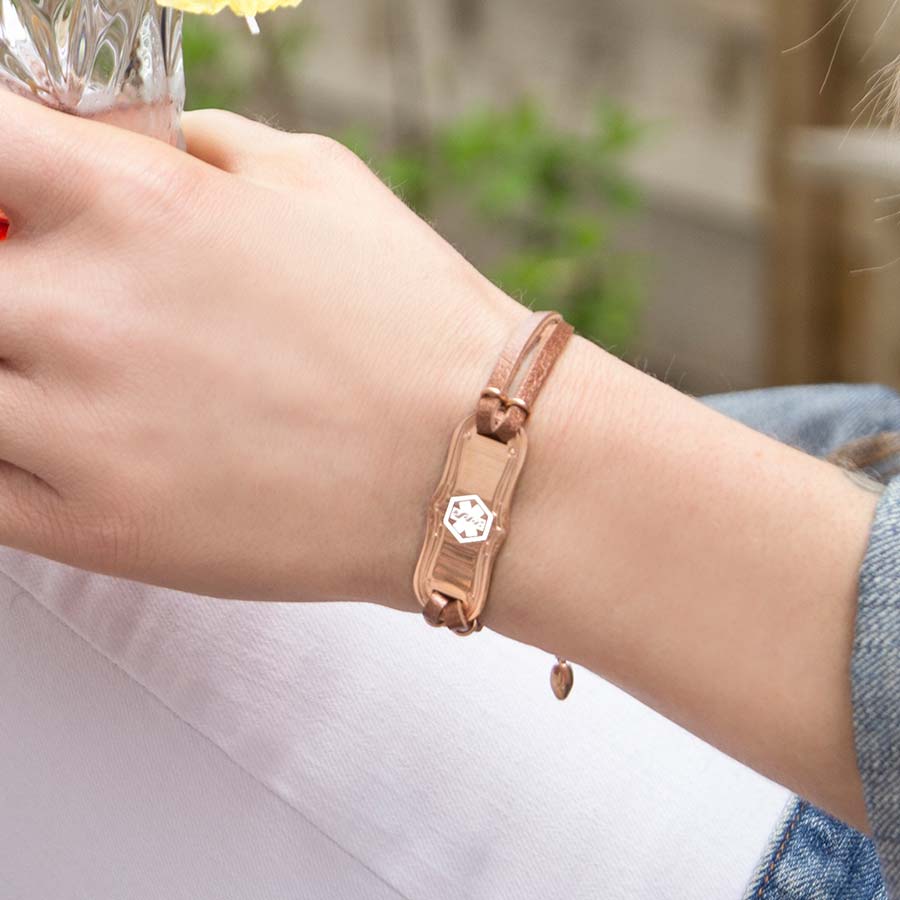 Woman wearing Avery SmartSize Medical ID Bracelet with copper tone leather band and adjustable chain with another bracelet