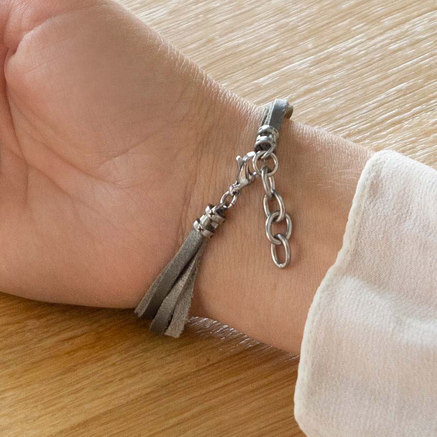 Woman showing silver tone adjustable clasp on Bella SmartSize Medical ID Bracelet