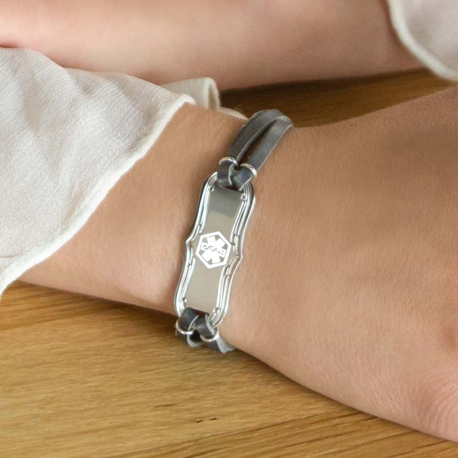 Woman wearing medical ID bracelet with silver leather and La Petite medical ID tag