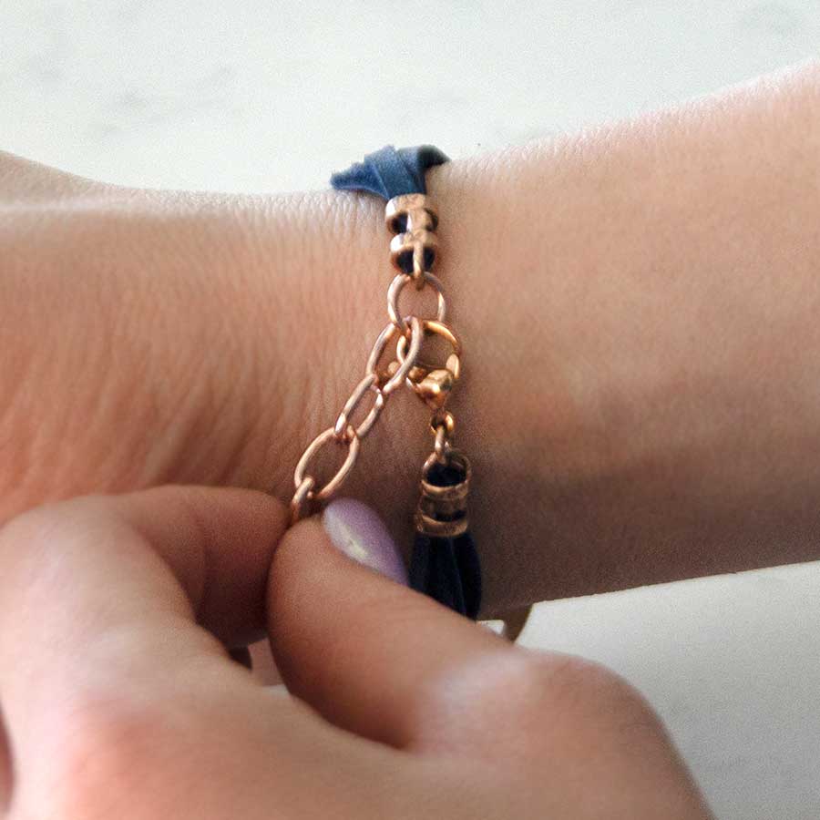 Woman showing rose gold clasp on adjustable medical ID bracelet