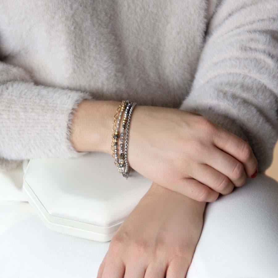 Woman wearing gold and silver beaded medical alert bracelet