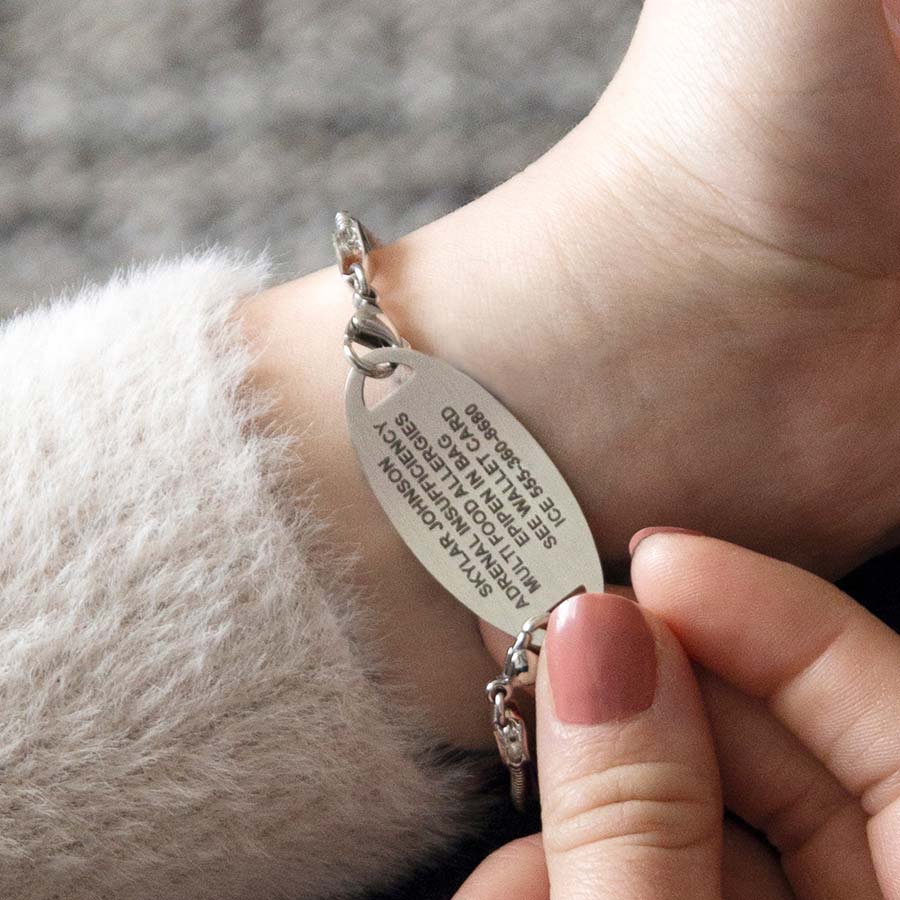 Woman showing custom laser engraving medical ID tag