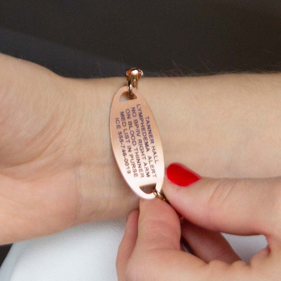 Woman showing custom laser engraving medical ID tag