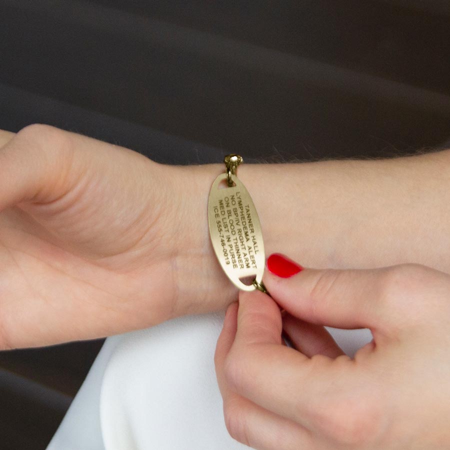 Woman showing custom laser engraving medical ID tag