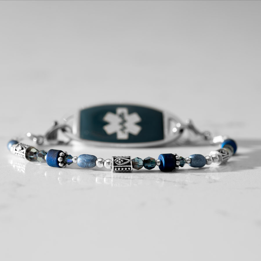 Blue and silver beaded medical ID bracelet on jewelry elastic with stainless steel lobster clasps and sapphire blue decorative med ID tag.