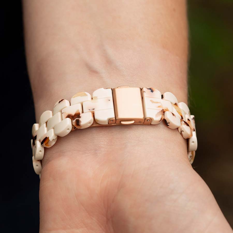 Woman with back of wrist turned to display closed rose gold clasp on resin medical ID bracelet. 