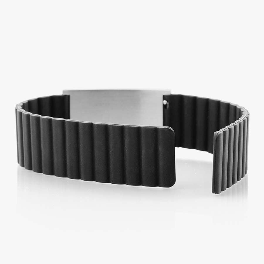 Low back angle of black silicone, magnetic band with silver tag and open band. 