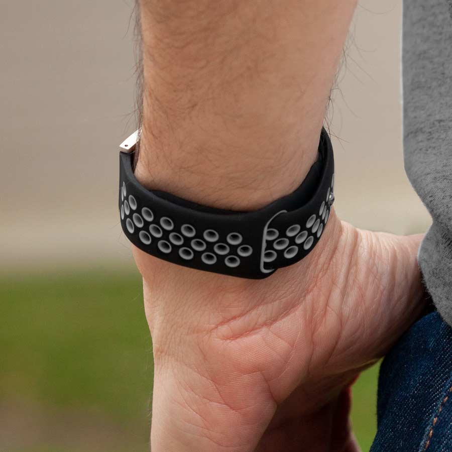 Man showing clasp of black silicone medical alert bracelet