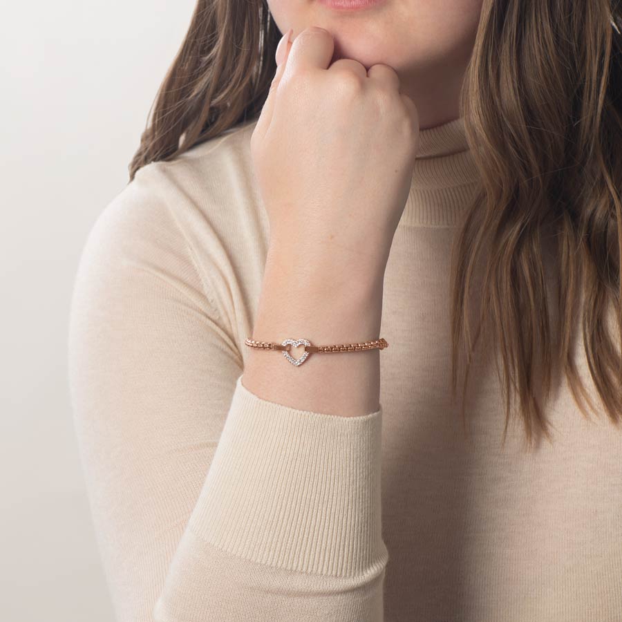 Woman wearing rose gold and crystal heart medical ID bracelet