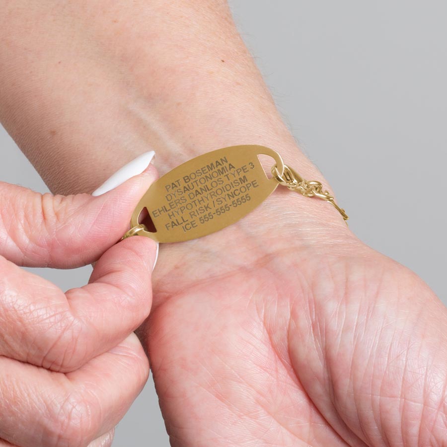 Woman showing custom laser engraved medical ID alert tag