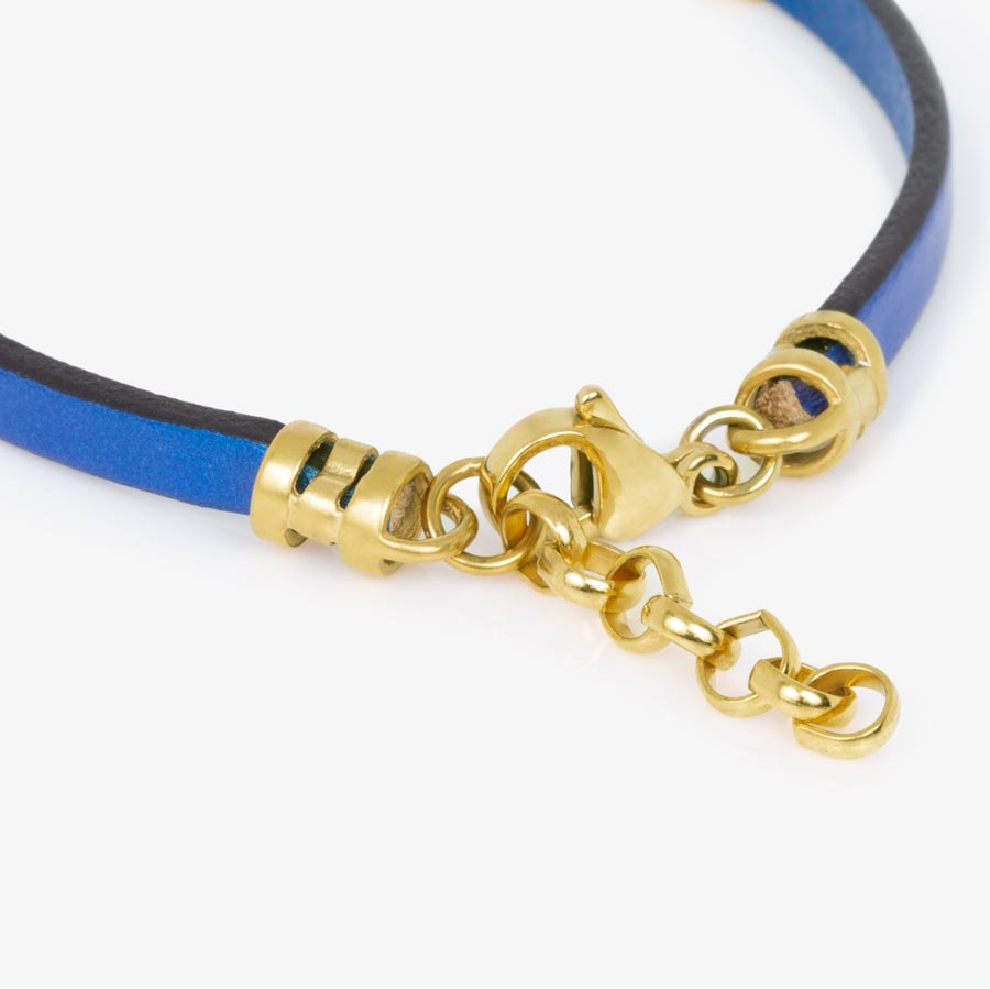 Detailed image of navy blue metallic leather bracelets gold tone adjustable chain and lobster clasp.