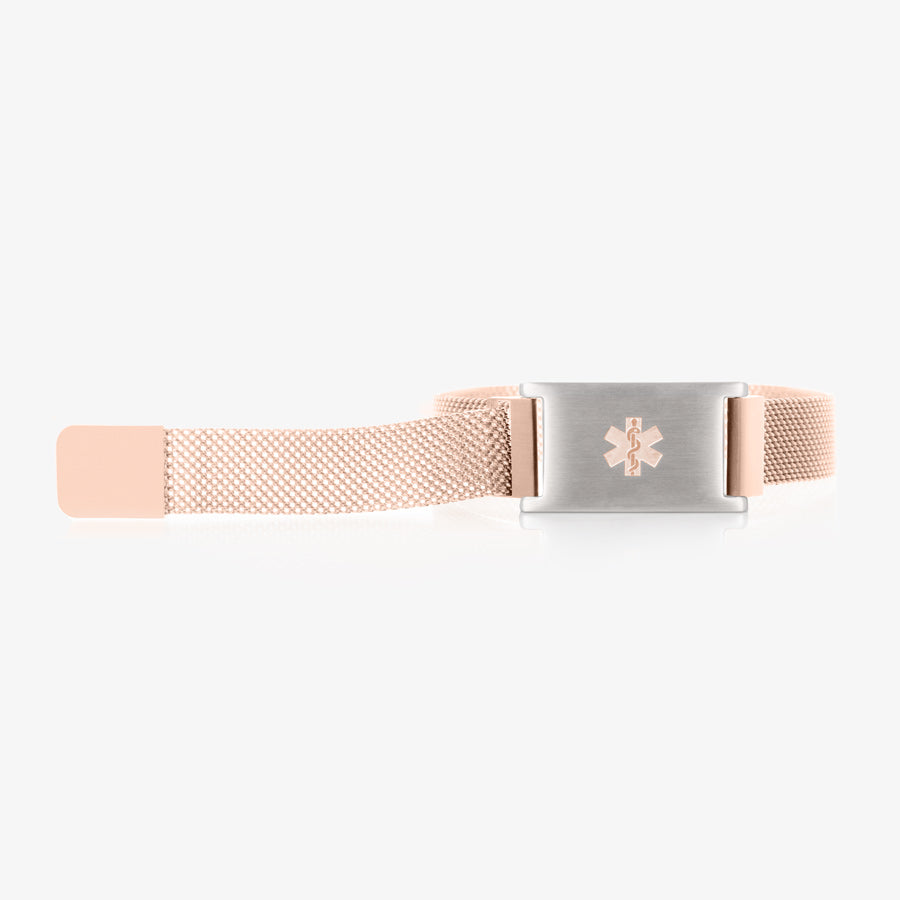 Rose gold tone stainless steel mesh band laid out with stainless steel medical ID tag with rose gold tone medical symbol.