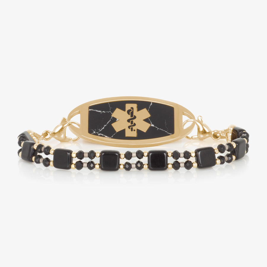 Black and gold beaded stretch women's medical alert bracelet paired with gold tone stainless steel medical ID tag with black paint inlay and gold tone medical symbol at the center.