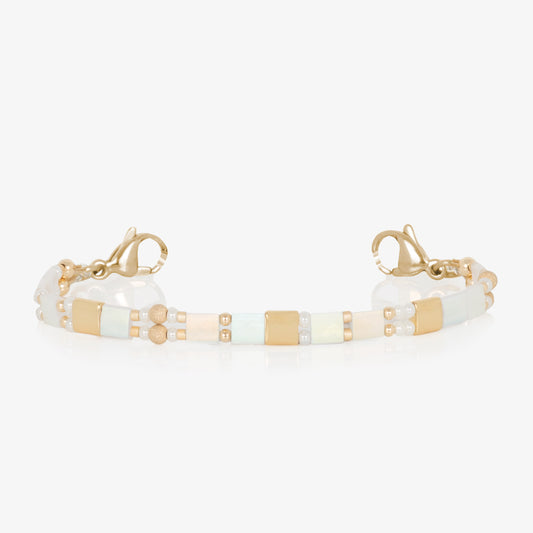 White and gold beaded stretch medical ID bracelet finished with gold tone stainless steel lobster clasps.