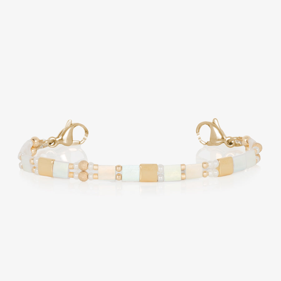 White and gold beaded stretch medical ID bracelet finished with gold tone stainless steel lobster clasps.