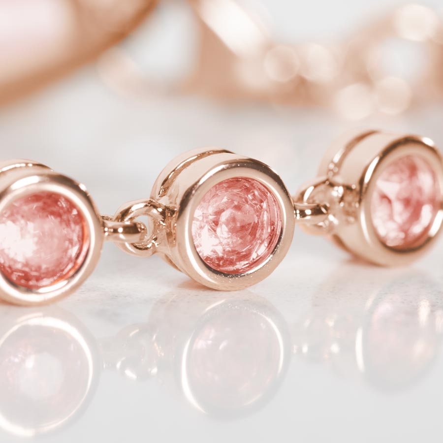 Close up image of round, bezel set, Light Rose Cubic Zirconia Crystals