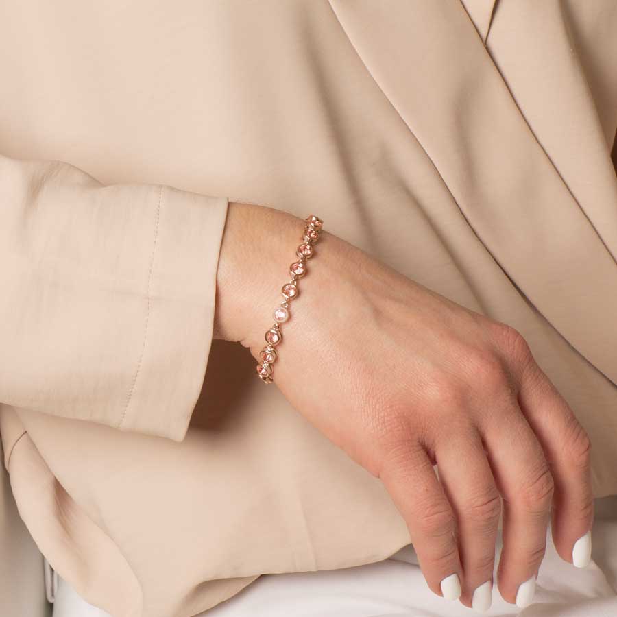 Woman wearing Ella Medical ID Bracelet in Rose Gold with round, bezel set, Light Rose, Cubic Zirconia Crystals